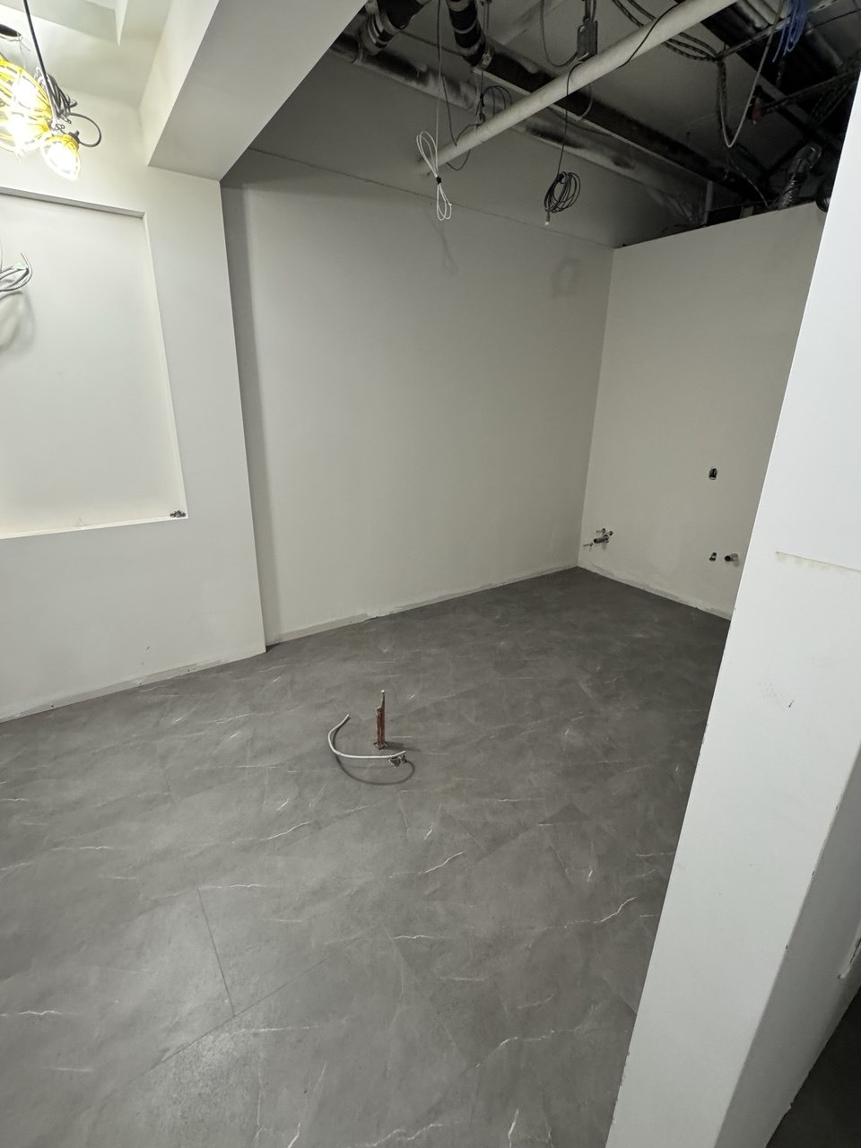 Glue-down vinyl flooring installation in a dental office treatment and reception area (view 2)