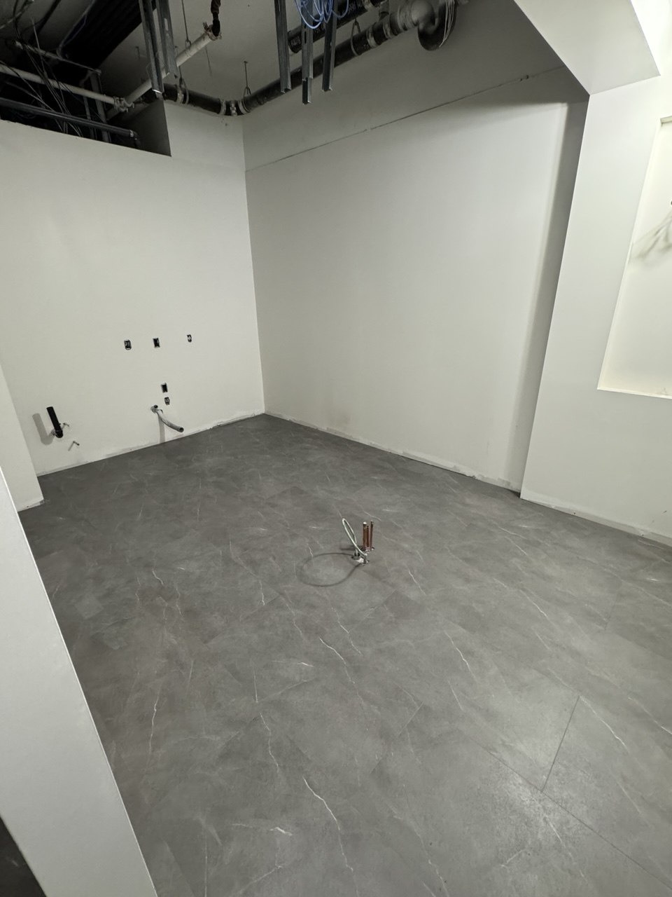 Glue-down vinyl flooring installation in a dental office treatment and reception area (view 4)